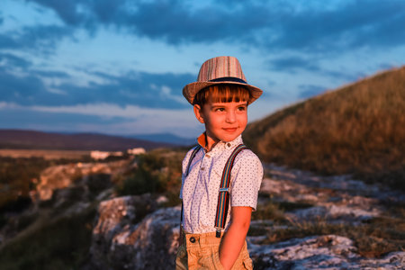 Little pretty  boy is smiling. He looks like the little actor of old movie. Retro style that is...