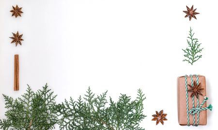 Christmas holidays composition. Christmas knitted gifts, evergreens and spices on white background. Flat lay, top view, copy space.の写真素材