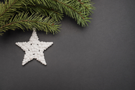 Christmas tree and star on black background. Festive concept.の写真素材