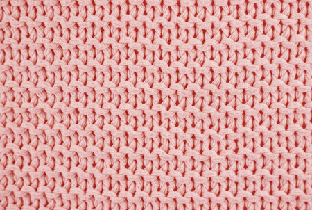 Knitted texture in Living Coral color of 2019 year. Close up, flat lay.の写真素材