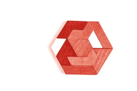 A hexagon tangram puzzle in Living Coral - color of year 2019. Isolated on white.の写真素材