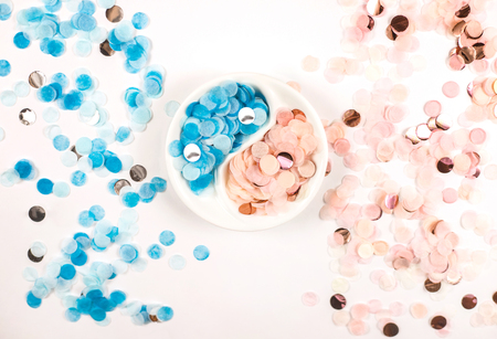 Bright multicolored confetti isolated on a white background. Festive concept. Childrens party, birthday, wedding, celebration. Top view. Copy space.の写真素材
