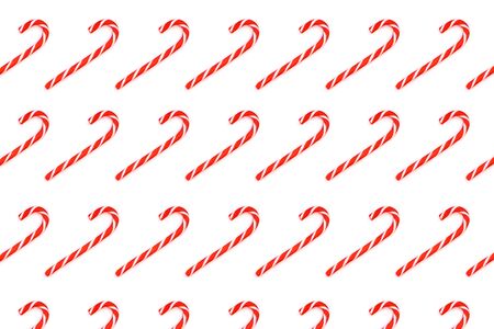 Pattern made from Christmas candy canes isolated on white backhround. Christmas holiday concept.の写真素材