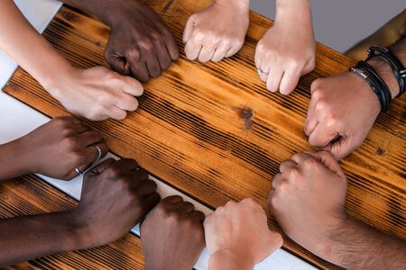 Close up of multiracial students hands making fist bump gesture. Teamwork and people equality concept.の写真素材