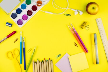 Different school supplies on bright yellow paper background. Back to school background. Flat lay, copy space.の写真素材