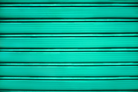 Bright metal green painted shutter or roller blind.