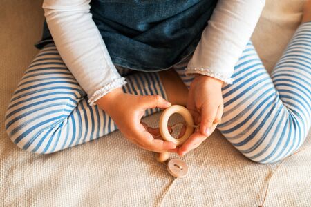 Childs hands threading beads and making bracelet. Close up.の写真素材