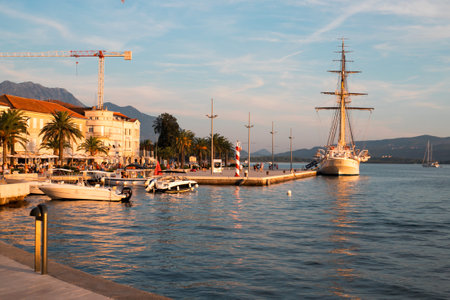 TIVAT, MONTENEGRO - SEPTEMBER 16, 2019: Wonderful view of waterfront promenade of beautiful town of Tivat, Montenegro. Warm autumn on the seaside. Sunset.のeditorial素材