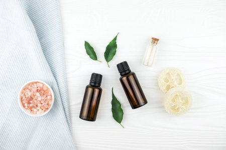 Homemade spa cosmetic set with salt and oil on white wooden background.の写真素材