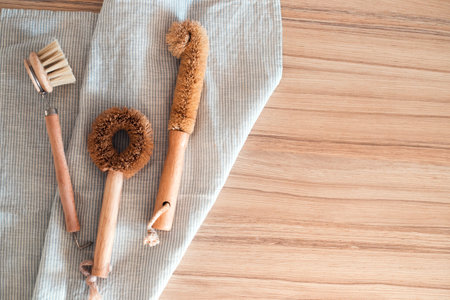 Eco-friendly kitchen set of brushes on cotton towel. Zero waste concept. Flat lay style.