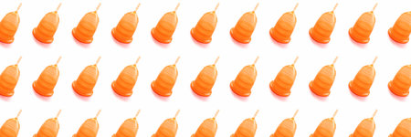 Banner made from orange menstrual cup on white background. Isolated.