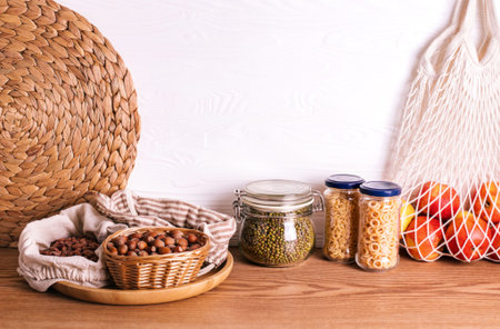 Variety of grains and legumes in glass jars and eco bags. No waste storage conceptの写真素材