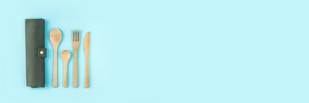 Banner made from eco friendly bamboo cutlery set on blue