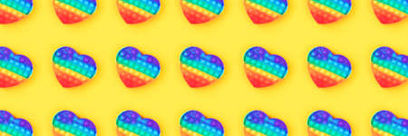 Banner from pattern with rainbow toy isolated on yellow background.の写真素材