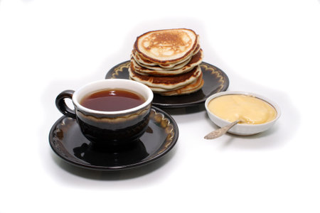 Photo of pancakes, tea and honey is on a white background.の写真素材