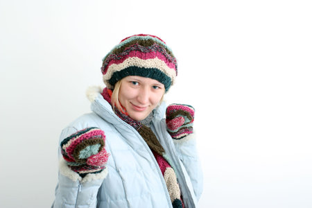 Portrait of the woman in a winter cap, mittens and a scarf.の写真素材