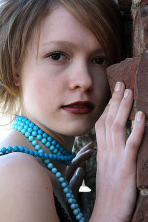 Portrait of the girl at a wallの写真素材