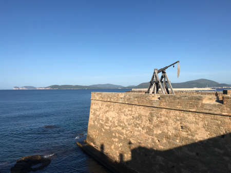 catapult on seafront bastion in alghero, sardinia, italyの写真素材