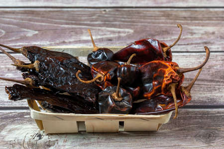 Various dried Pasilla, Cascabel, Guajillo hot chili peppers.の写真素材