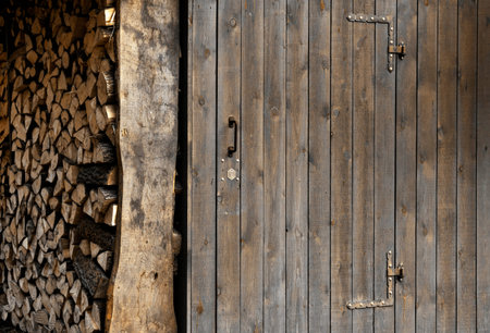 Wooden planks doors close to firewood near it.