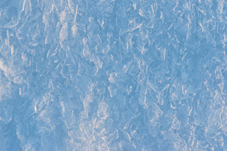 winter theme background of frozen ice crystals at sunny day.