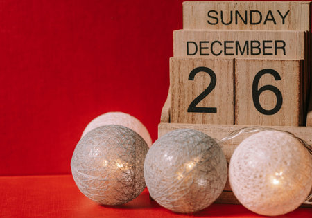 Festive wooden calendar of December 26 2021 years Sunday on red background.の写真素材