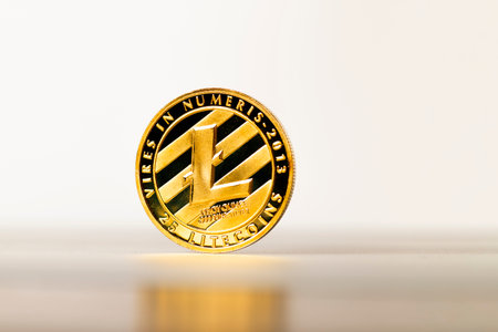 Close-up of golden color litecoin coin with reflection.の写真素材