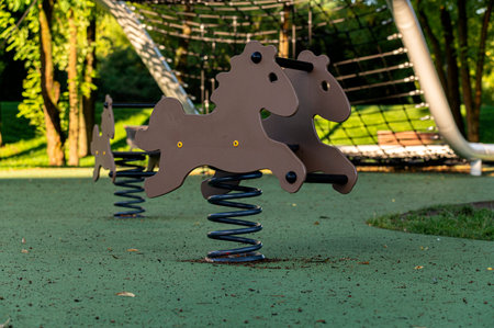 Modern horse shape toys in kids playground at nature.