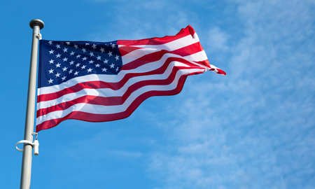 Flag of United States waving in the wind at sunny day.