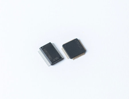 Close-up of two microchips on a clean white background, highlighting electronic components,...