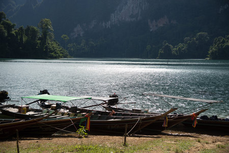 Thailand long tail boat stop by the beach near river.