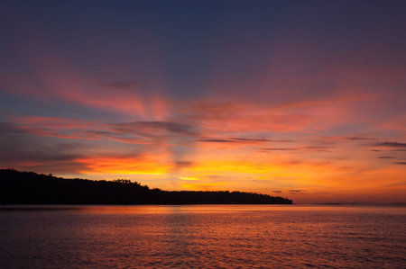Sunset by the land from seaの写真素材