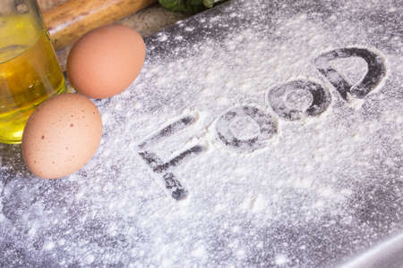 Bakery flour and leafy greens and oil and tow eges foodの写真素材