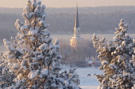 Winter church at dawnの写真素材