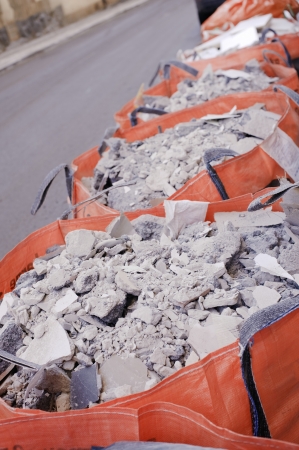 Full construction waste bags in a row の写真素材