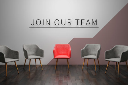Job recruiting advertisement represented by'join our team' texts on the chairs or wall. One chair is colored differently to represent the hiring position to be recruited and filled.3d renderの写真素材