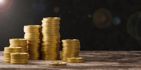 Stack of gold coins on black background.の写真素材