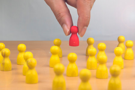 Human resource, Talent management, Recruitment employee, Successful business team leader concept. Hand chooses a wooden people standing out from the crowd.の写真素材