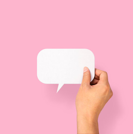 Hand holding an empty speech bubble