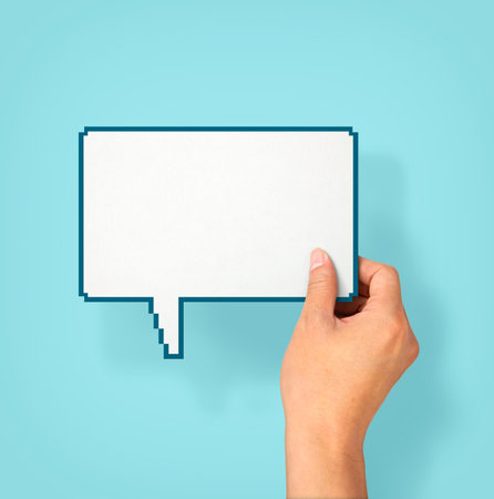 Hand holding an empty speech bubbleの写真素材