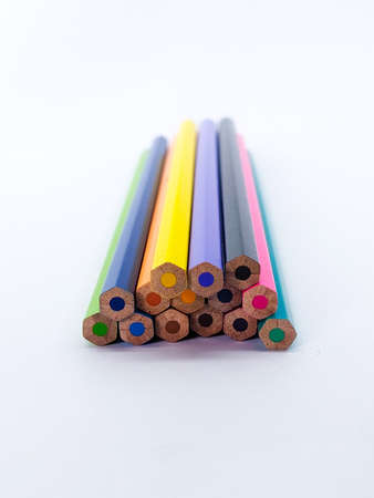 Stack of wooden multi colored pencils showing the back part on white backgroundの写真素材