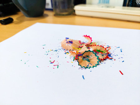 Close-up colorful pencil shavings on white background