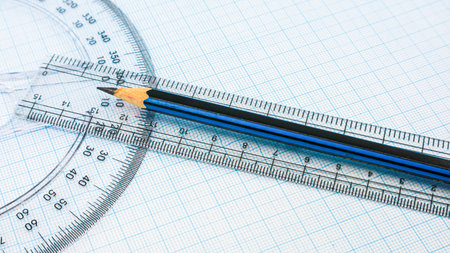 Pencil with compasses and rulers on a graph paper. Extremely close-up high angle photo. concept of...