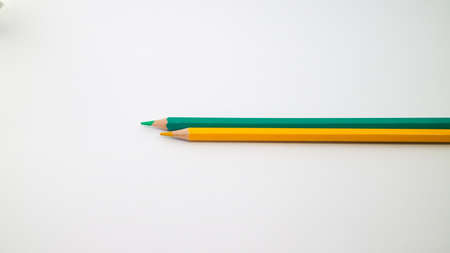 Two pencils on the white background. Yellow and tosca.の写真素材