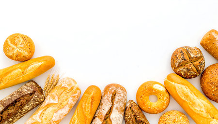 Different types of bread on white background. Top view with copy spaceの素材