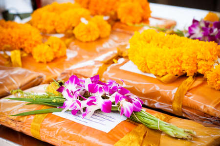 offering dedicated to Buddhist monks flower and clothes setの写真素材