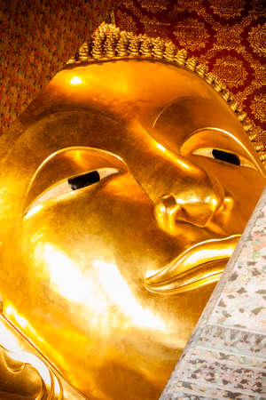 BANGKOK THAILAND  JUNE 2015: Head of golden reclining Buddha in Wat Pho temple on June 5 2015 in Bangkok Thailand. Wat Pho is named after a monastery in India where Buddha is believed to have lived.のeditorial素材