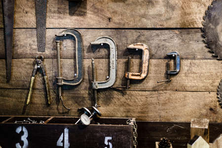 Old and used antique carpenter and handyman tools with  an aged rustic wood toolbox in a vintage carpentry workshopの写真素材