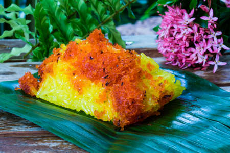 Red shrimp and shred coconut on yellow sticky rice. Thai style sweet dessert.の写真素材