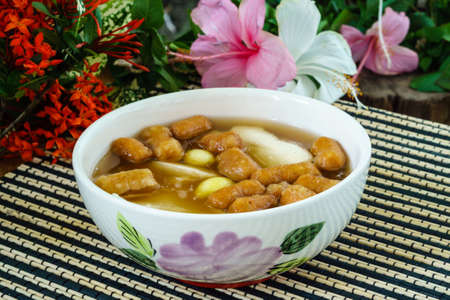 Bean junket eaten hot with gingered sirup, Ginkgo nuts, and mini deep-fried dough stickの写真素材